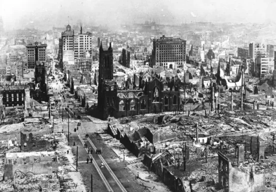 Aerial view of a cityscape after destruction, featuring ruined buildings and debris.